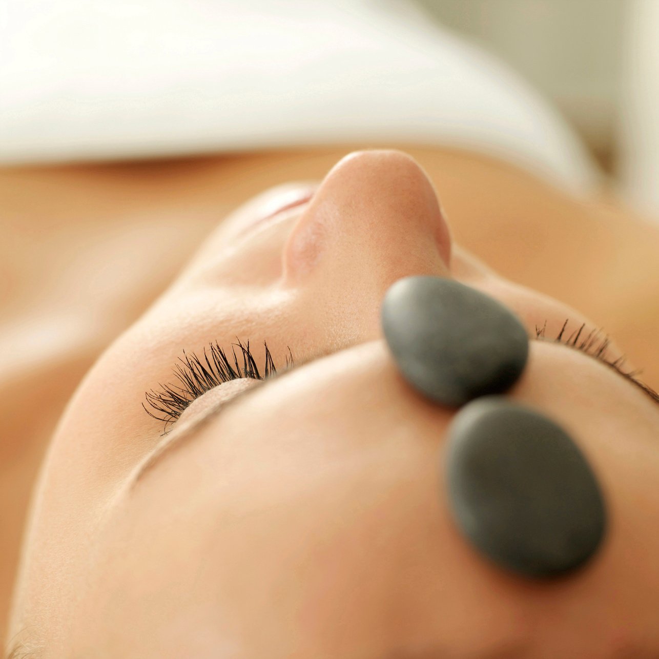 Woman receiving hot stone treatment