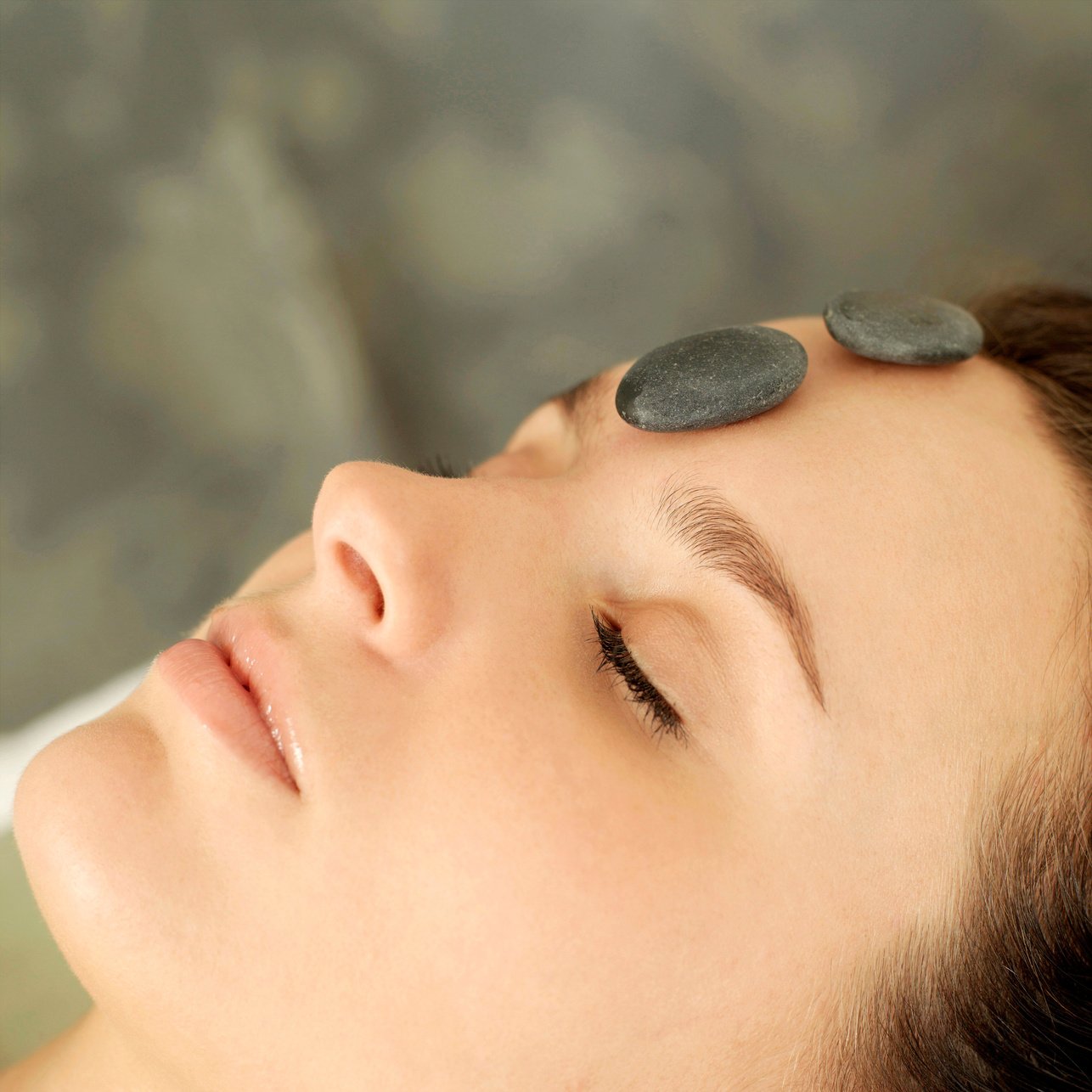 Woman receiving hot stone treatment